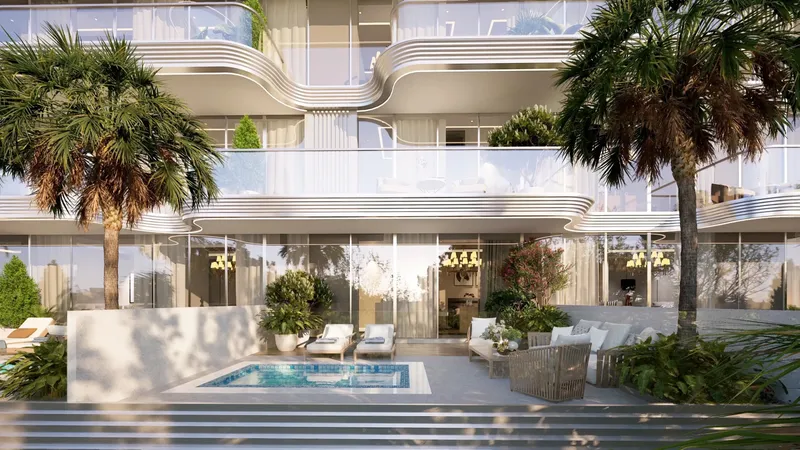 Terrace with a plunge pool and loungers below curved balconies at Meriden Beach Residences
