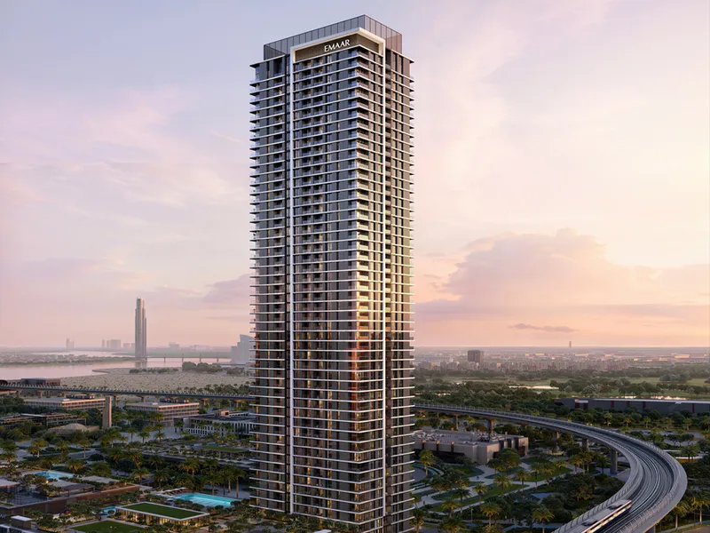 Render of the Montiva by Vida tower at sunset beside the elevated metro line in Dubai Creek Harbour