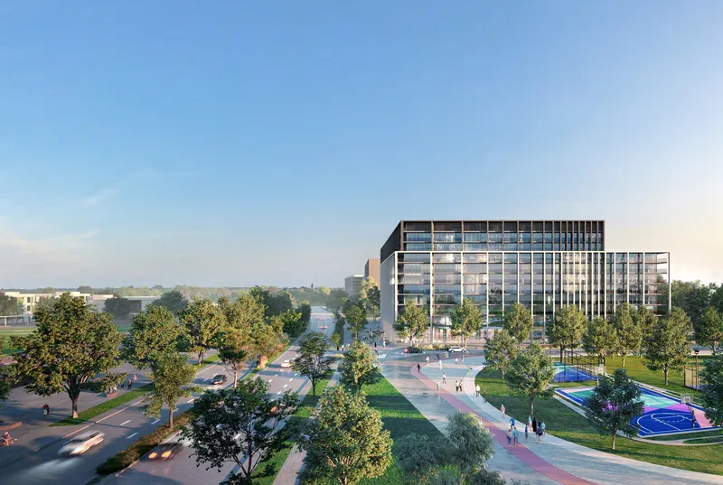 Aerial render of a Nesba apartment building at Aljada beside tree-lined roads, a park and sports courts
