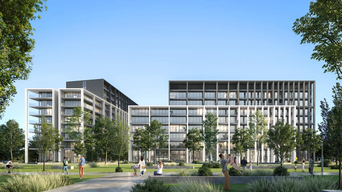 Render of the Nesba apartment buildings at Aljada, Sharjah, seen across a landscaped park with people walking and sitting on the lawns