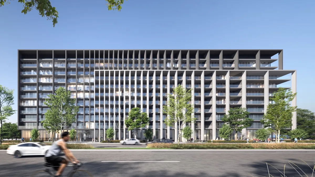 Render of the Nesba 2 apartment building at Aljada, Sharjah, with a dark grid facade and white fins, seen across a tree-lined road