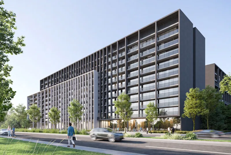 Render of the Nesba 3 apartment building at Aljada with a dark grid facade, seen from a tree-lined street