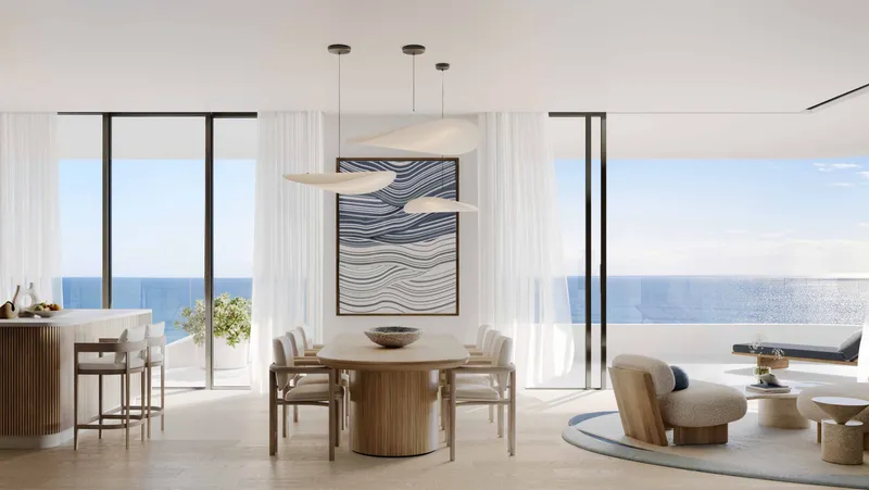 Open living and dining room with full-height windows facing the sea in a Nikki Beach Residences apartment
