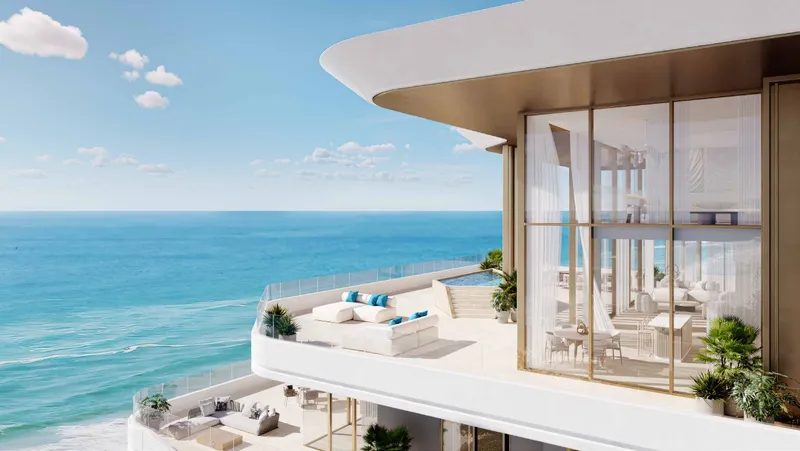 Double-height glazed home with a wide curved terrace above the sea at Nikki Beach Residences