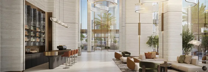 Double-height lobby lounge with a café counter at Nine Collective