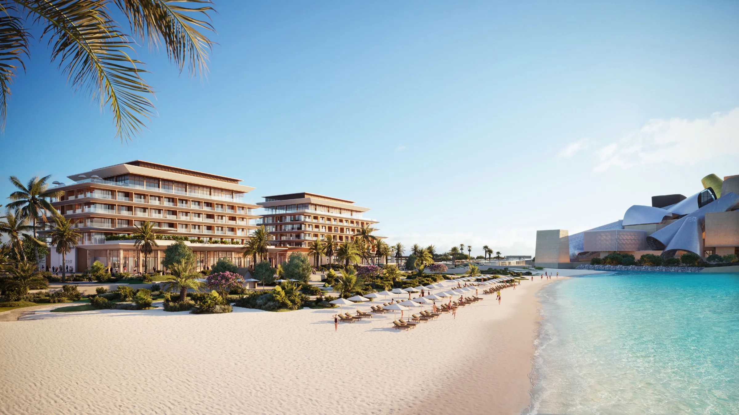 Nobu Residences Abu Dhabi seen from the beach, low terraced buildings behind palm trees and sunbeds