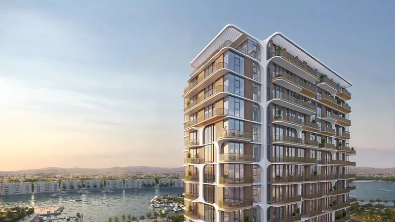 Render of a Nura tower with the harbour behind it at sunset