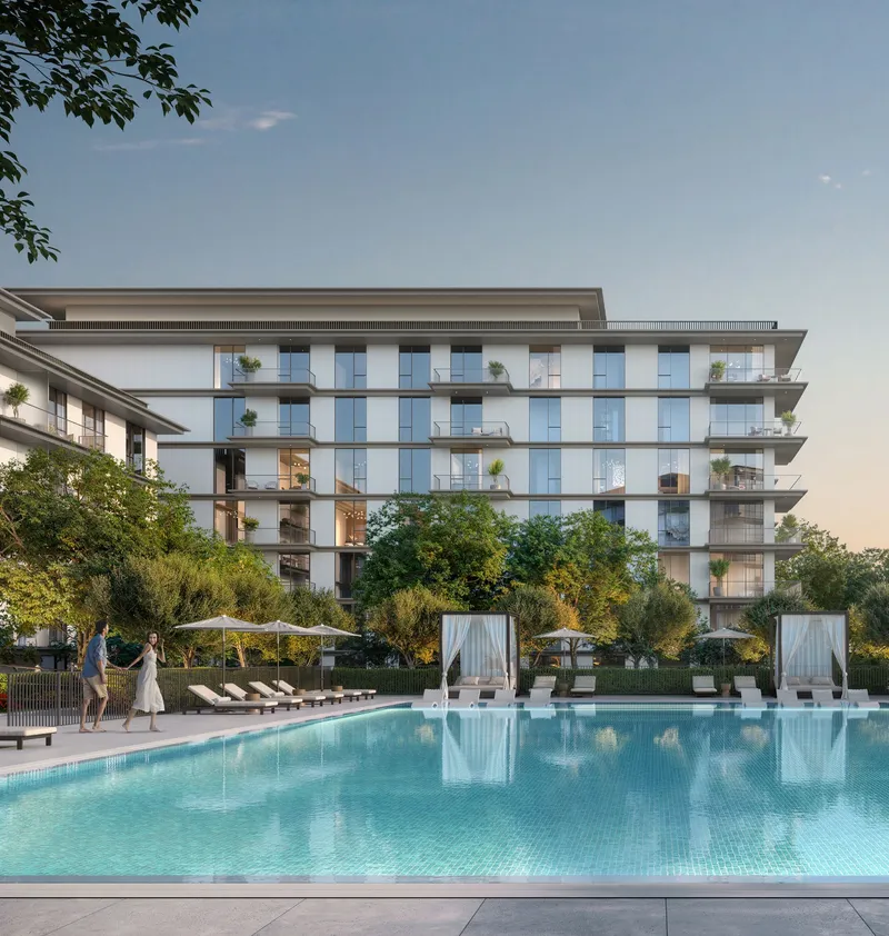 Render of an Ocean Cove apartment building seen across the swimming pool at dusk
