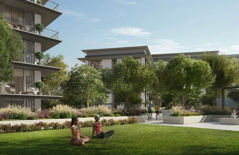 Render of residents on a lawn in the Ocean Cove gardens beside the apartment buildings