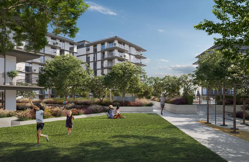 Render of children playing on the central lawn at Ocean Cove with the apartment buildings behind