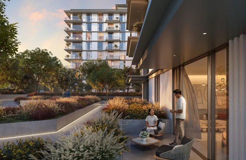 Render of a ground-level terrace at Ocean Cove opening onto planted gardens at dusk