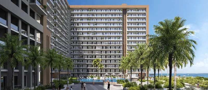 Oceana's apartment blocks around a landscaped pool courtyard, with the sea beyond (developer render)