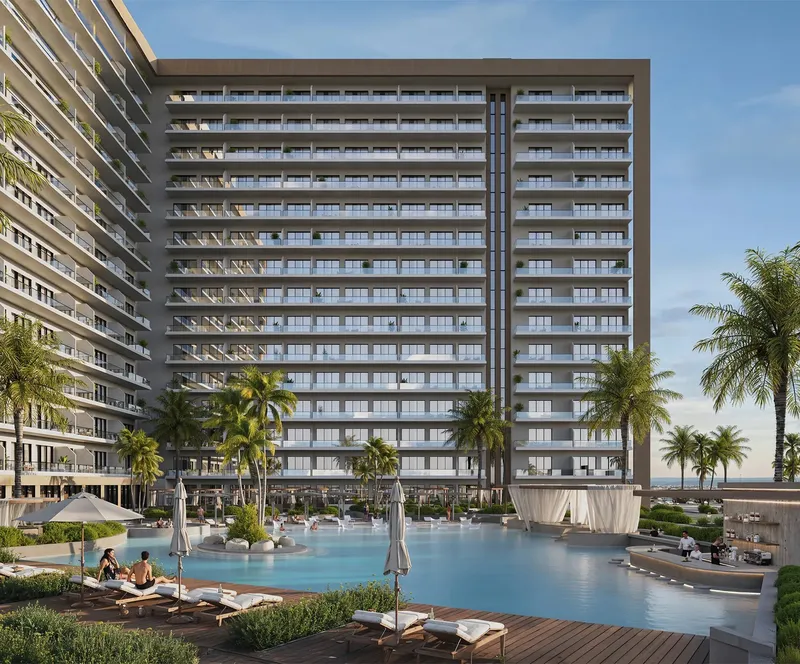 Oceana residential tower behind a palm-lined pool deck with sun loungers in Dibba Al Fujairah (developer render)