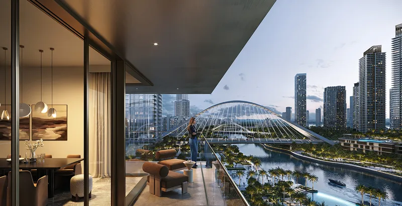 Render of a resident on a Palace Residences Creek Blue balcony looking over the water and an arched bridge at dusk