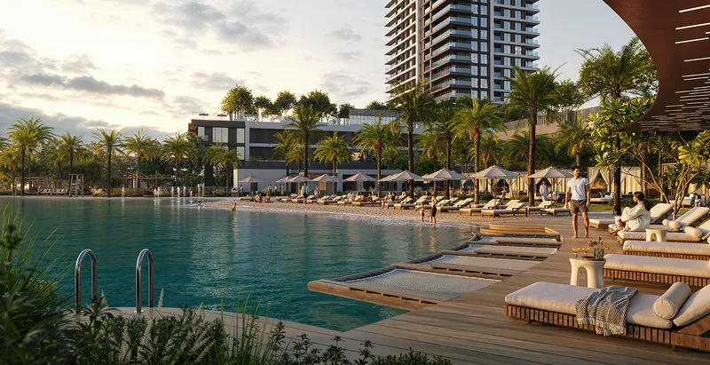 Render of the Palace Residences Creek Blue pool deck with sun loungers and the tower rising behind palm trees