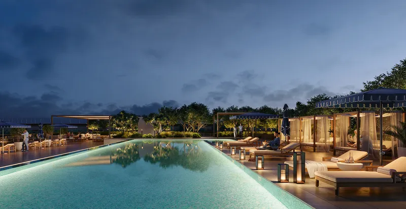 Render of the Palace Residences Creek Blue swimming pool at dusk with cabanas and loungers