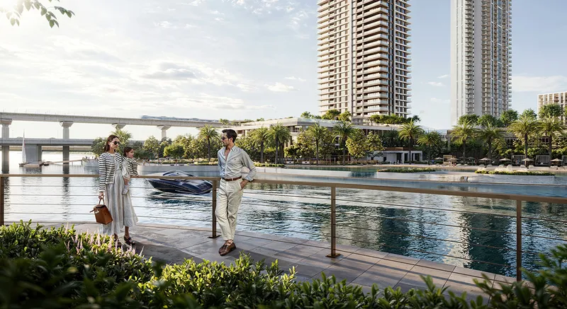 Render of a couple walking on the waterfront promenade with the Palace Residences Creek Blue towers across the water