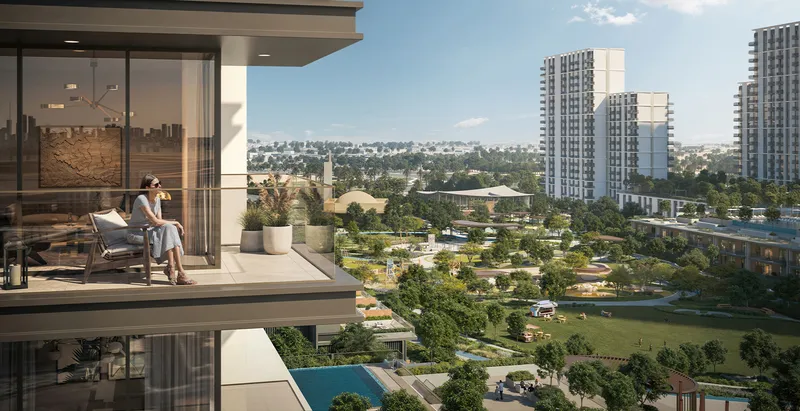 Render of a resident on a Palace Residences Hillside balcony looking over the park and Dubai Hills Estate