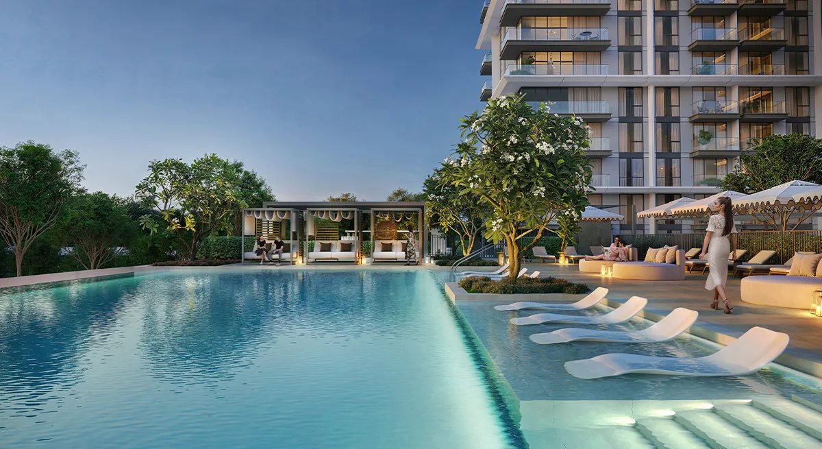 Render of the Palace Residences Hillside swimming pool at dusk with in-water loungers and cabanas