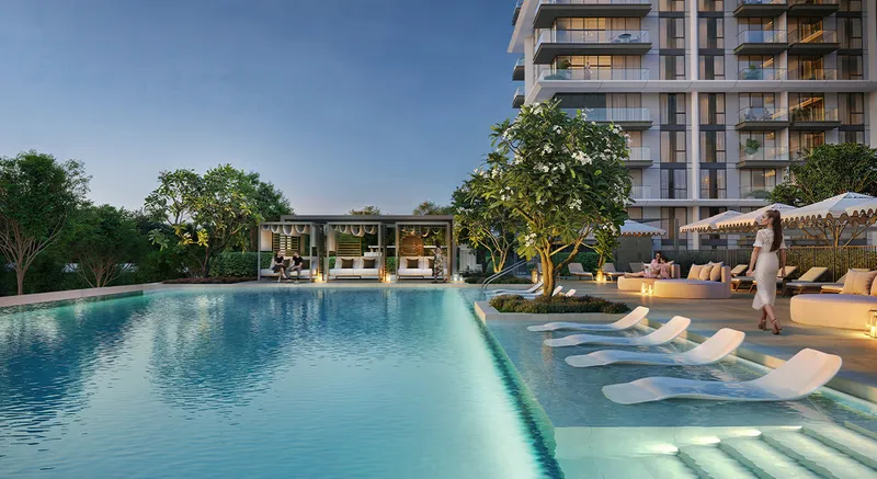 Render of the Palace Residences Hillside swimming pool at dusk with in-water loungers and cabanas