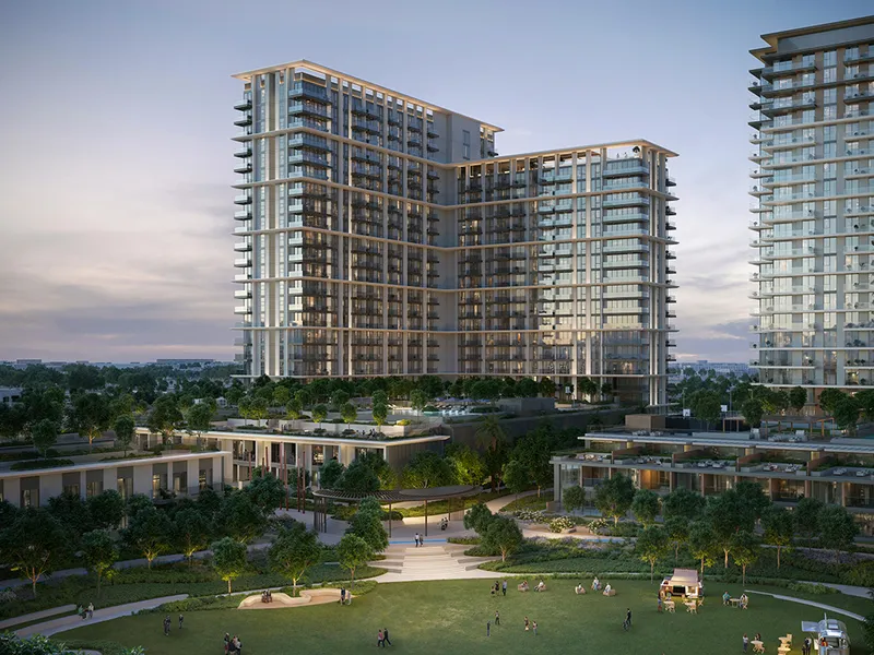Render of the Palace Residences Hillside tower at dusk above its podium, townhouses and the park lawn
