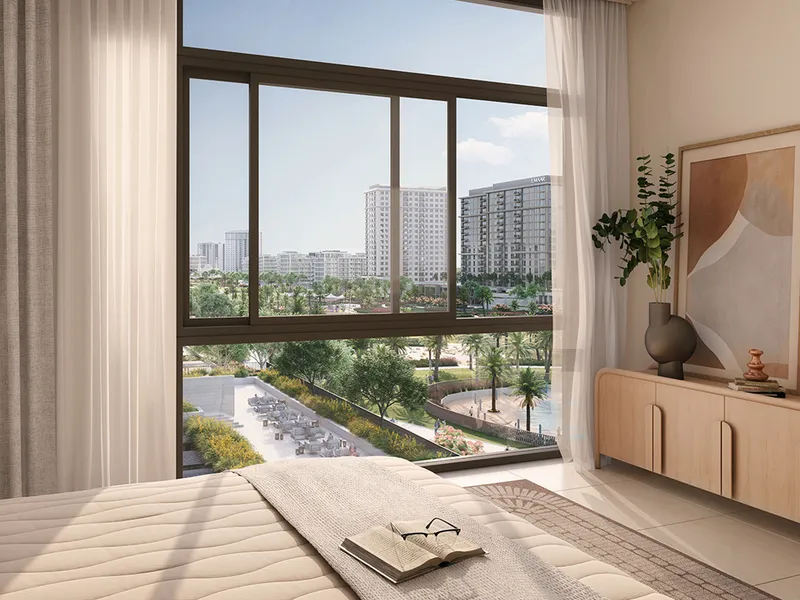 Bedroom at Parkside Views with a full-width window overlooking the park