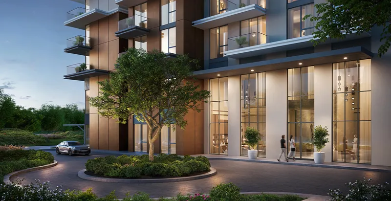 Render of the Parkwood entrance and drop-off at dusk with double-height lobby glazing