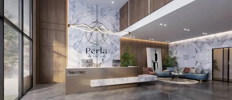 Double-height lobby at Perla 2 with marble walls, a reception desk and a lounge (developer render)