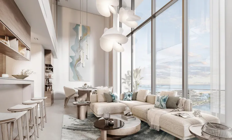 Double-height living room with full-height windows in a duplex at Pristine Beach Residences