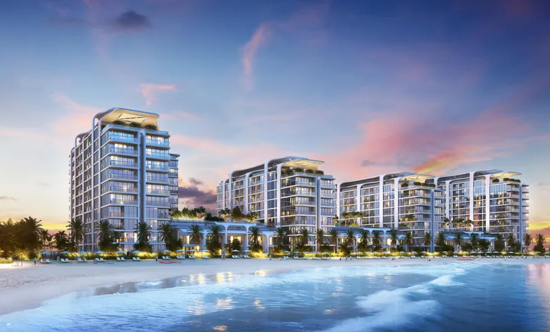Pristine Beach Residences at dusk with the beach in the foreground