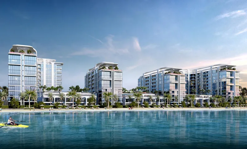 The four buildings of Pristine Beach Residences seen across the seawater lagoon