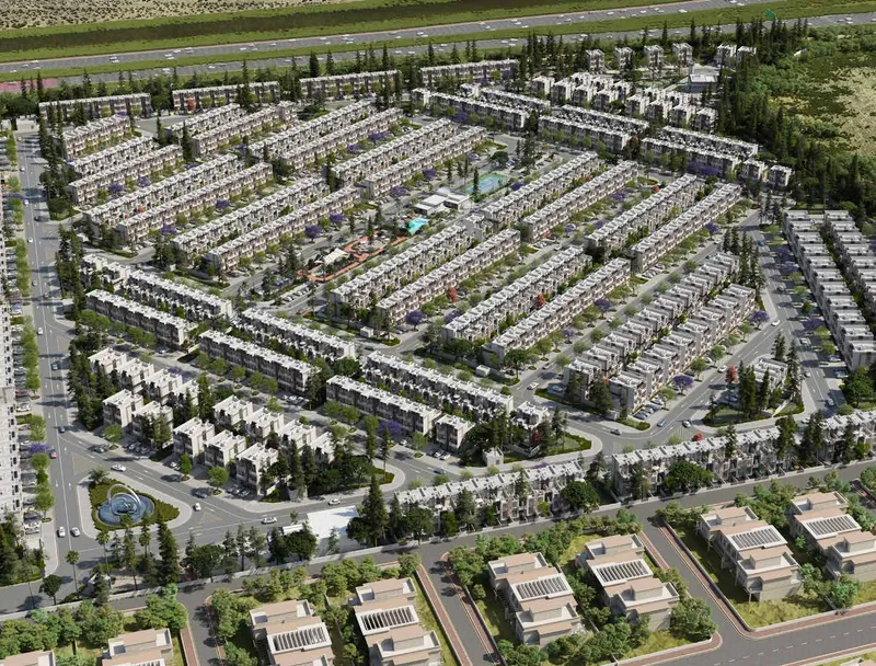 Aerial view of R. Hills in Dubailand: rows of townhouses around landscaped streets and a central green (developer render)