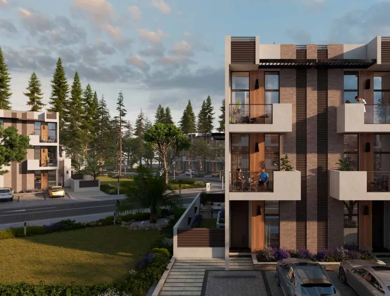 An R. Hills townhouse with front garden, balconies and roof terrace at sunset (developer render)