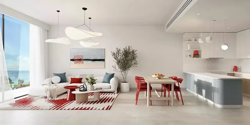 Furnished living and dining room with an open kitchen and a sea-facing window in a Rosso Bay Residences apartment