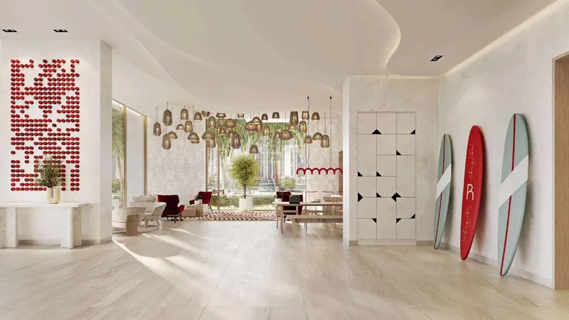 Lobby with a curved ceiling, hanging woven lights and red and white surfboards at Rosso Bay Residences