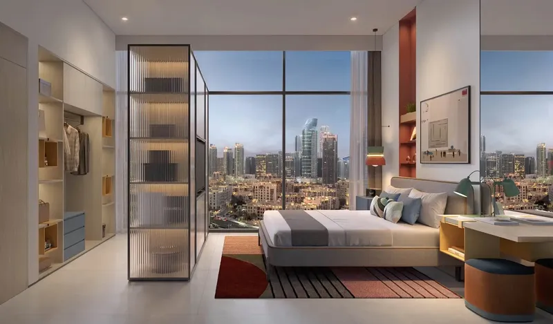 Furnished bedroom with glass-fronted wardrobe and floor-to-ceiling windows at Rove Home Downtown Dubai