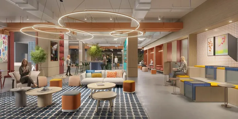 Co-working and lounge area with ring pendant lights and patterned floor at Rove Home Downtown Dubai