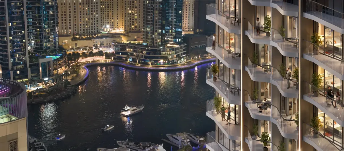 Render of Rove Home Dubai Marina balconies at night overlooking the marina, its yachts and the lit towers opposite