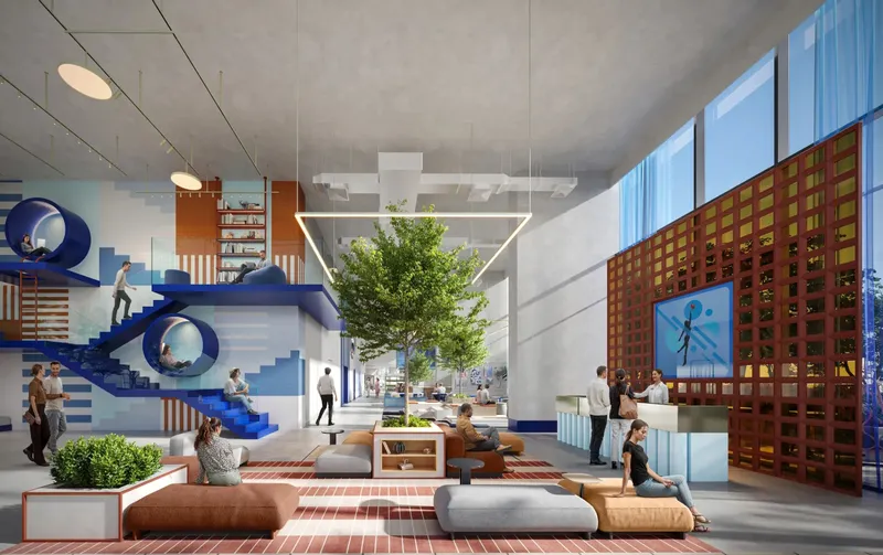 Double-height entrance lobby with a feature staircase, lounge seating and a tree at Rove Home Dubai Marina