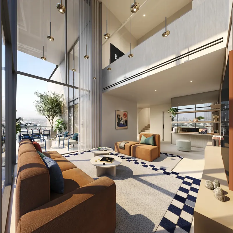 Double-height living room of a Sky Loft with tall windows and a mezzanine at Rove Home Dubai Marina