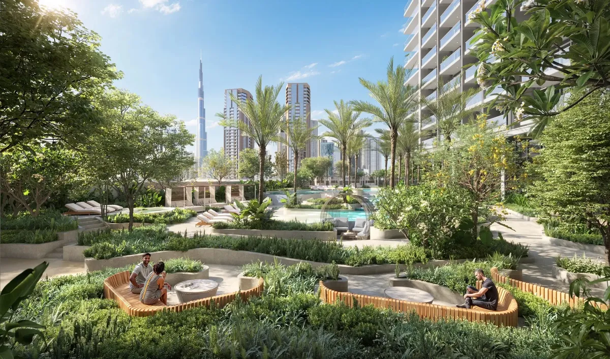 Landscaped podium garden with seating, palm trees and a pool, with the Burj Khalifa in the distance
