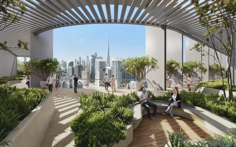 Rooftop garden with a timber pergola, planting and seating looking towards Downtown Dubai