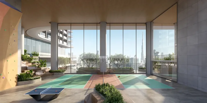 Sky garden level with a ping pong table, sports court and glazed views towards the Burj Khalifa