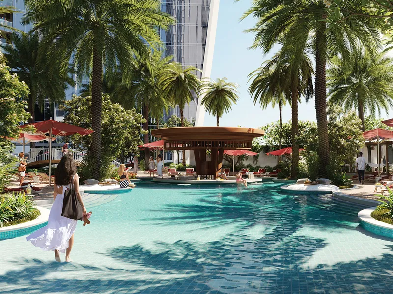 Render of the podium-level beach pool at Safa Two, edged with palm trees and cabanas