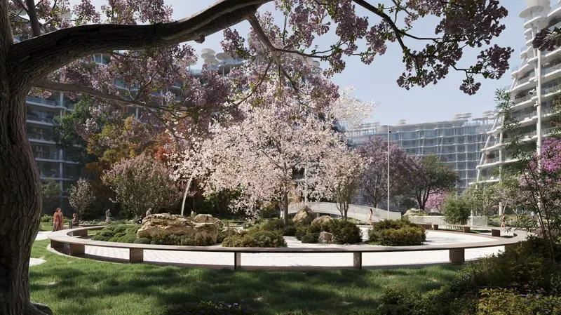 Blossom trees around a circular planted seat in the Sakura Gardens central park