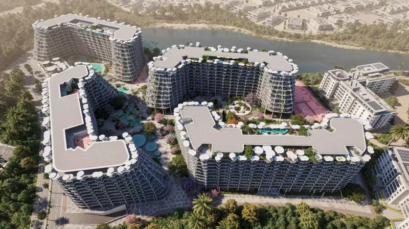 Aerial view from above of the Sakura Gardens buildings, central gardens and the lagoon behind
