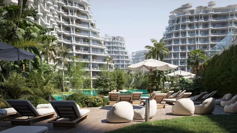 Timber deck with loungers and parasols by the pool between the Sakura Gardens buildings