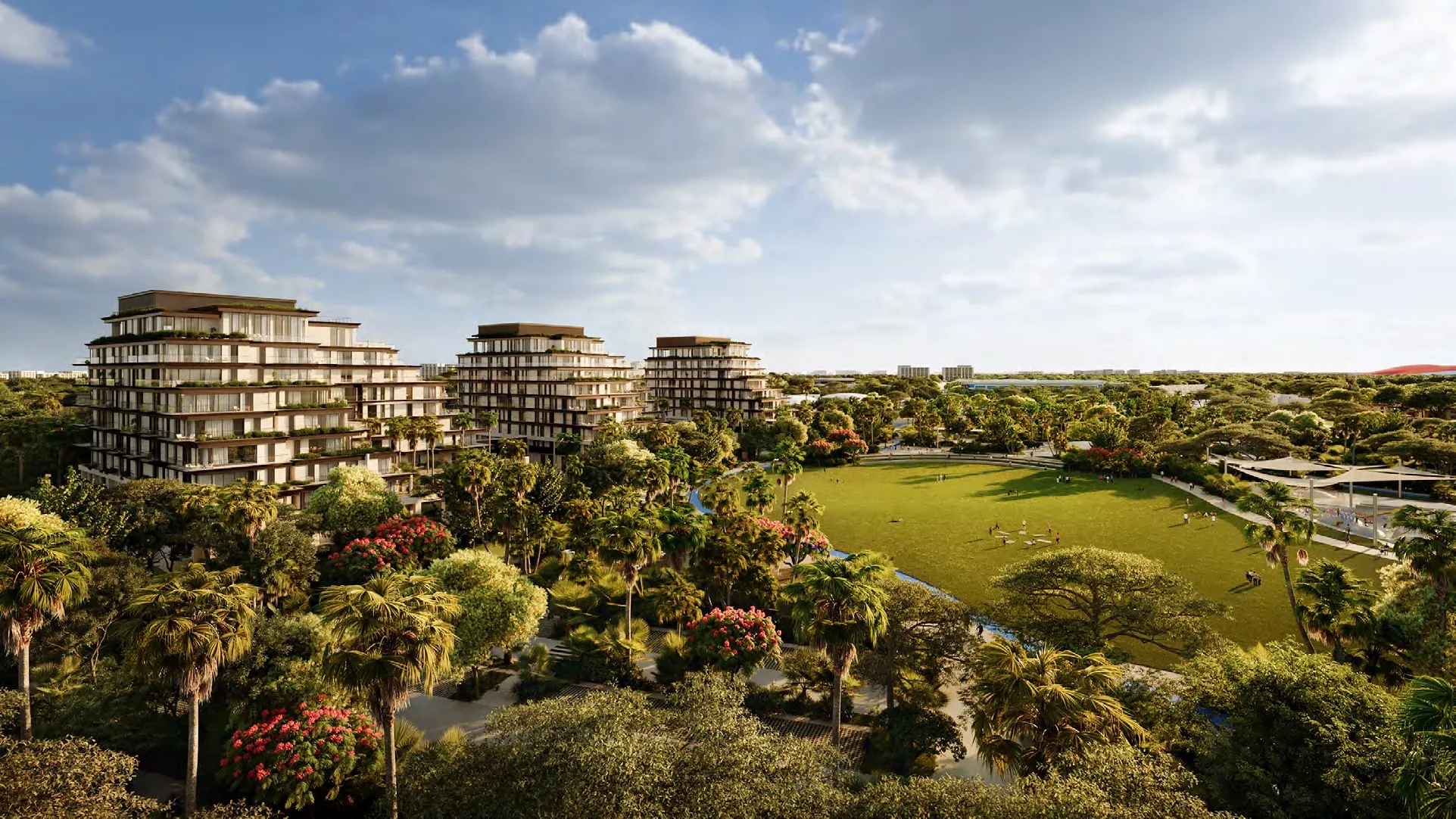 Aerial render of the three Sama Yas buildings beside the lawns and trees of Yas Park on Yas Island