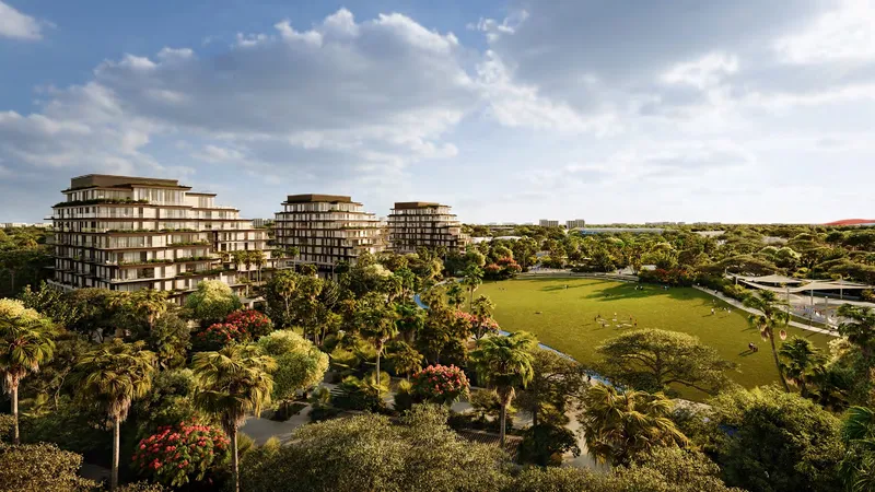 Aerial render of the three Sama Yas buildings beside the lawns and trees of Yas Park on Yas Island