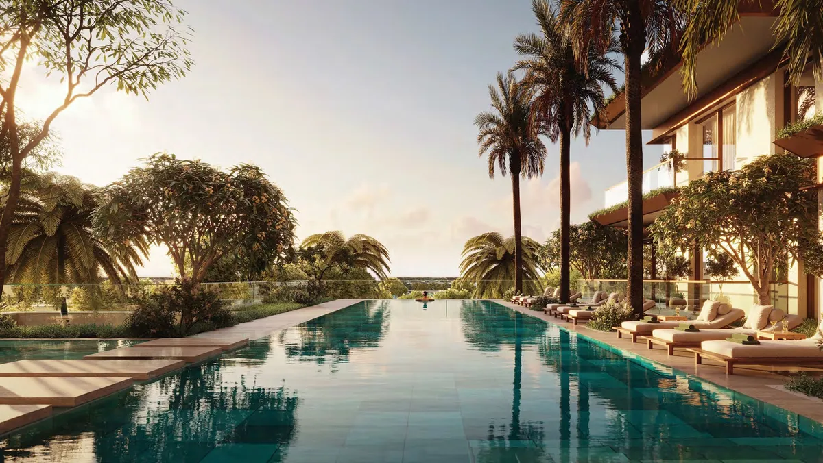 Render of the Sama Yas infinity pool lined with palms and sun loungers at dusk